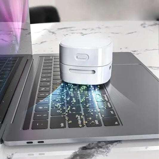 Mini desktop vacuum cleaner benefits highlighted as it cleans a laptop keyboard.