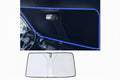 A car windshield sun visor with a silver reflective surface and a cute eye design, displayed in a folded position, with an inset showing the visor in use on a car windshield.